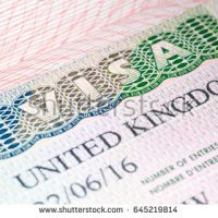 stock-photo-visa-to-uk-united-kingdom-visa-vignette-in-passport-macro-image-selective-focus-645219814